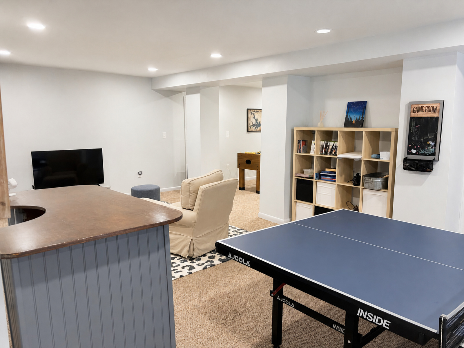Lower-level recreation room with ping pong table